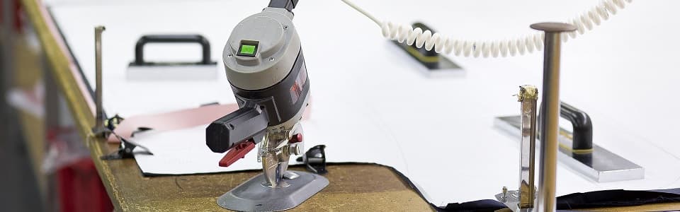 Industrial fabric cutter on the cutting table